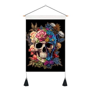 Floral skull tapestry detail showing vibrant prints, black tassels and wooden hanging rod