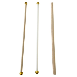 Details of wooden hanging rods with gold ball finials in white and natural wood finish