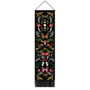 Detail of bohemian tapestry featuring mushrooms and butterflies with black fringe tassels