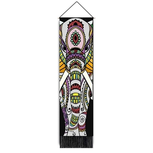 Detail of Bohemian wall tapestry featuring a colorful ethnic elephant and black tassels