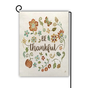 Detail of linen Thanksgiving garden flag with pumpkin pattern and Be Thankful text