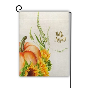 Close-up of linen garden flag with pumpkin sunflower design and Hello August text
