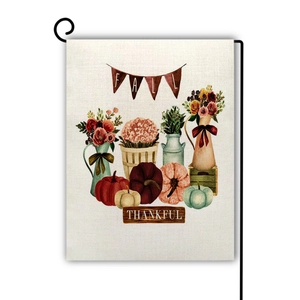 Detail of harvest pumpkin garden flag with linen texture and fall thankful wording
