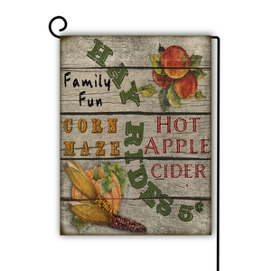 Detailed harvest flag with pumpkins and hay ride text on a black metal garden stand