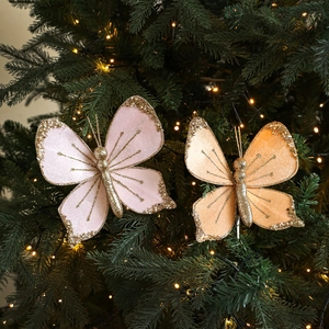 Pink and orange velvet butterfly Christmas ornaments with gold glitter and pearls on tree