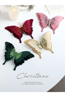 Dettaglio di fiocchi natalizi in velluto con centro glitterato e clip metalliche in vari colori