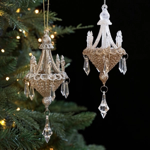 Glittering chandelier Christmas ornaments with faux crystal drops on festive background