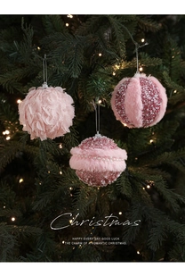 Detail of pink Christmas balls with faux fur, feathers and pearls on festive tree