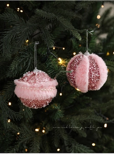 Pink plush Christmas ball ornaments with pearls and glitter hanging on tree