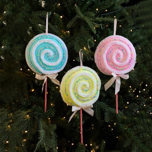 Trois sucettes de Noël colorées en peluche avec paillettes et nœuds blancs