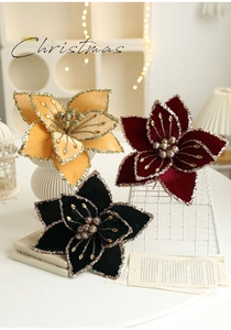 Close-up of velvet Christmas flowers with gold sequins and glitter center decoration