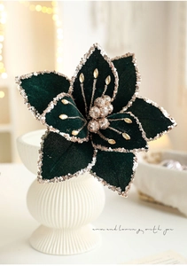 Detail of dark green velvet Christmas flower with gold sequins and beads for decor