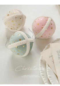 Close-up of 8cm velvet Christmas baubles with gold stars and woven string detail