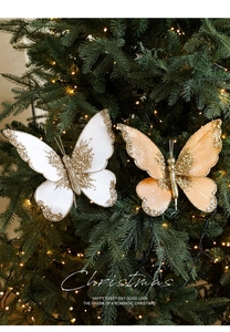 Detail showing white and champagne butterfly ornaments with gold glitter on a Christmas tree