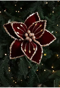 Close-up of velvet poinsettia Christmas flower with gold sequins and beads detail