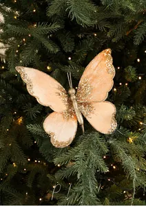 Close-up of peach butterfly Christmas ornament with gold glitter and white pearls