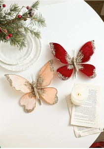 Detail of red and pink velvet Christmas butterfly clips with gold glitter and pearls