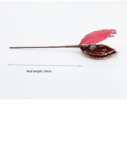 Detail of red fabric Christmas flower with silver sequins and 24cm brown stem