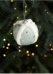 Detail of 8cm mint green fabric Christmas ball with gold stars and white knit ties