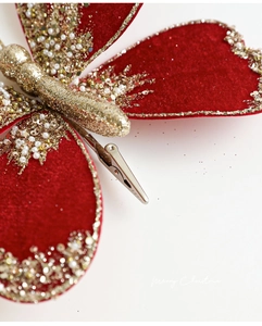 Detail of red velvet Christmas butterfly clip with gold sequins and glitter textures