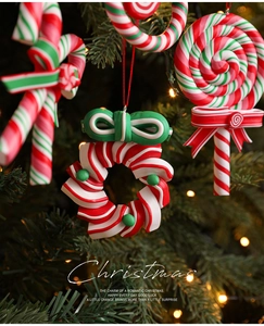 Macro detail of red and green candy cane ornaments hanging on a festive Christmas tree