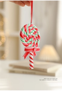 Detail of red white and green spiral Christmas candy ornament with striped bow and ribbon