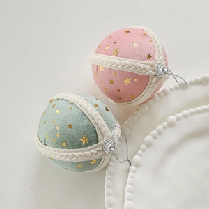 Pink and mint green fabric Christmas balls with gold star patterns and rope wrap