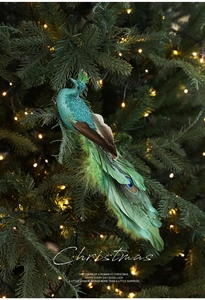 Detail view of peacock Christmas ornament with blue feathers on a lighted tree