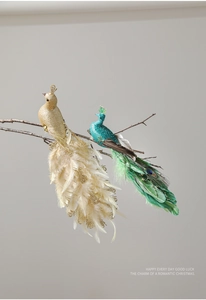 Close-up of decorative artificial peacocks with glitter and feathers on tree branches