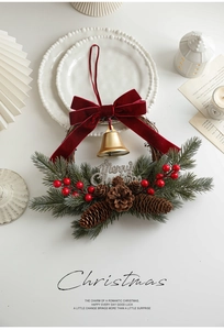 Detailed Christmas wreath featuring red velvet bow, metal bells, pine cones and berries