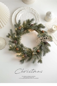Close-up of a pine needle Christmas wreath with LED lights, pine cones and wooden sign