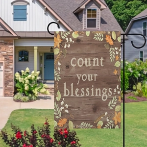 Count Your Blessings autumn garden flag with maple leaves on a rustic wood background
