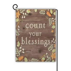 Linen garden flag with count your blessings text and autumn maple leaves on wood print