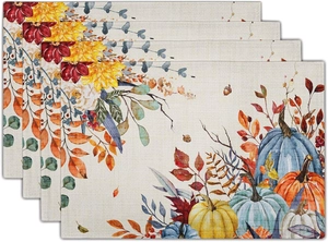 Detail of linen placemats with colorful pumpkins and autumn floral patterns set of four