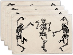 Detail view of four rectangular Halloween placemats with dancing skeletons on linen texture