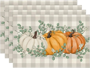 Set of four linen placemats with Thanksgiving pumpkin pattern and eucalyptus decor