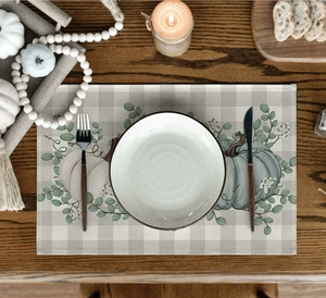 Linen placemat featuring pumpkin eucalyptus design and grey buffalo plaid pattern