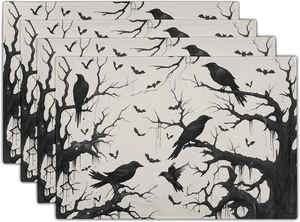 Close-up of four-piece Halloween placemats featuring gothic raven and dead tree prints