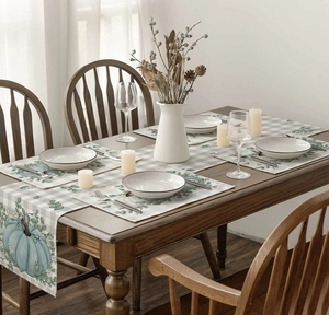 Linen table runner and placemats set featuring blue pumpkins and eucalyptus leaves
