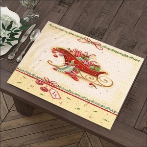 Detailed view of linen Christmas placemat with Santa sleigh print on wooden table