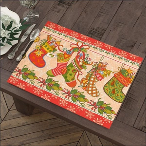 Detailed view of linen Christmas placemat featuring five festive socks on a wooden table