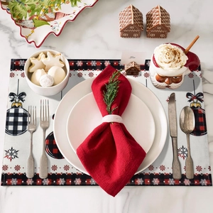 Christmas place mat with red plaid ornaments and snowflake patterns on marble table