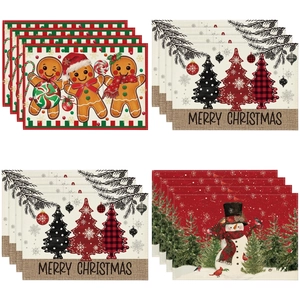 Detail of Christmas linen placemat showing stitched edges and snowman print