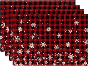 Close-up of four red and black buffalo plaid Christmas placemats with snowflake prints