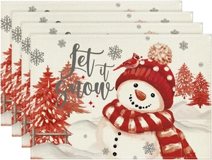 Close-up of linen-textured Christmas placemats featuring snowmen and Let it snow print
