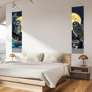 Set of two moon owl aesthetic tapestries with black tassels hanging in a modern bedroom