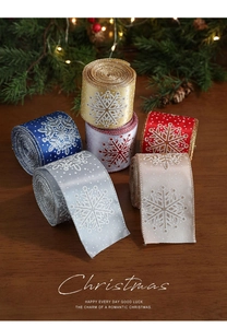 Close-up of Christmas ribbon rolls with snowflake patterns for gift wrapping and party decor