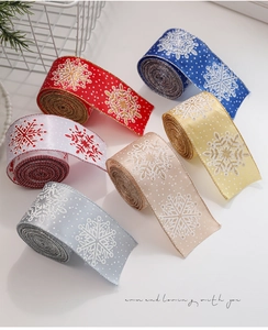 Close-up of Christmas ribbon rolls with glitter snowflakes and polka dots in six colors