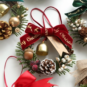 Christmas wreath with velvet bow, pine cones, and berries for holiday door wall decor