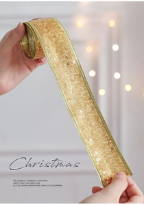 Close-up of golden sequin ribbon roll for Christmas gift wrapping and festive decor